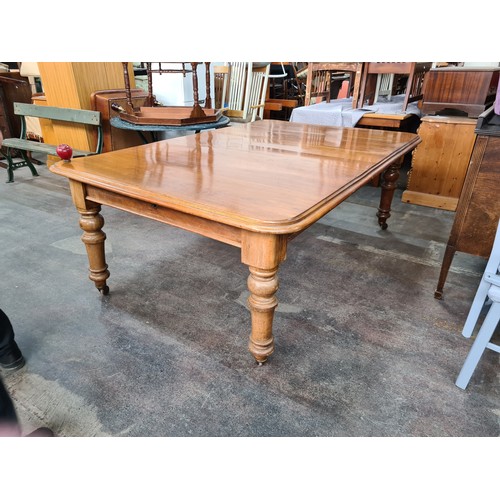 786 - Star Lot : A Super golden Oak Victorian Dining table, With round thick legs and a curved border a ve... 