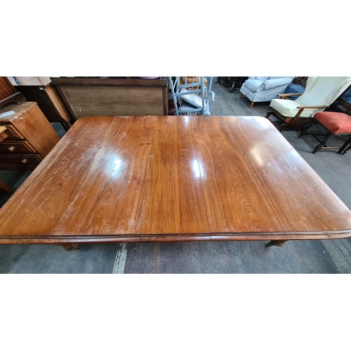 786 - Star Lot : A Super golden Oak Victorian Dining table, With round thick legs and a curved border a ve... 