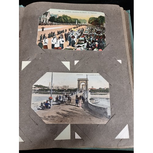 606 - A beautiful vintage postcard album holding a large variety of postcards depicting popular tourist de... 