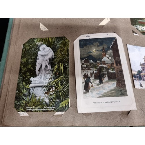 606 - A beautiful vintage postcard album holding a large variety of postcards depicting popular tourist de... 