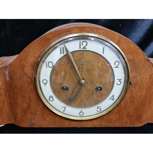 120 - A very attractive vintage mid-century eight day mantel clock made by Junghans. With a brass-toned an... 