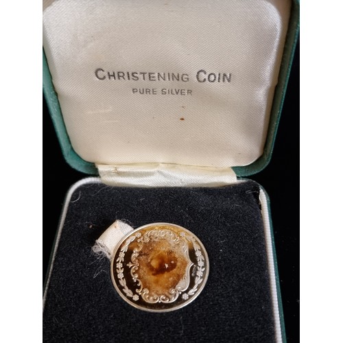 188 - Two sterling silver items including a Christening coin in presentation case with a sterling silver n... 