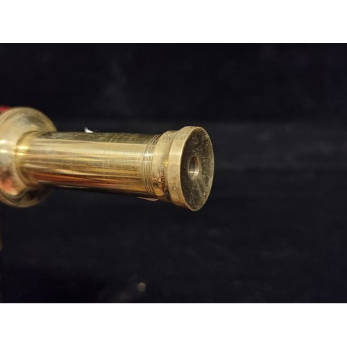 272 - An unusual walking cane with an integrated spyglass handle in a brass tone.