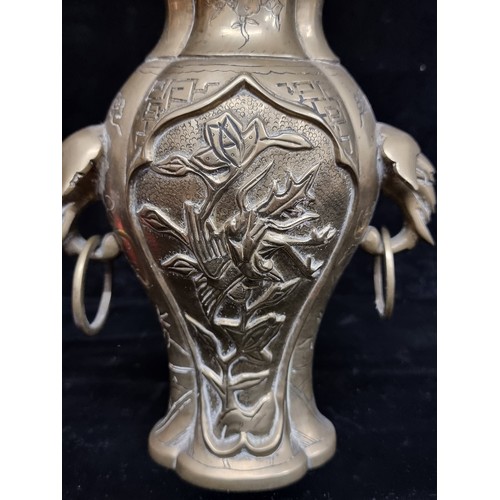 281 - A wonderful heavy solid brass vase boasting elaborate etched foliate motifs and ring handles.