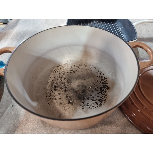 422 - Two very heavy enamel cast iron Le Creuset items including a lidded casserole pot and a griddle pan.