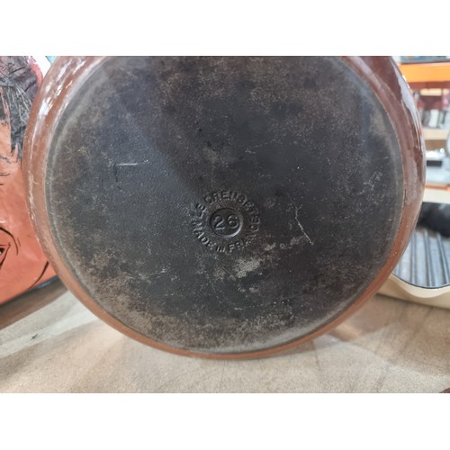 422 - Two very heavy enamel cast iron Le Creuset items including a lidded casserole pot and a griddle pan.