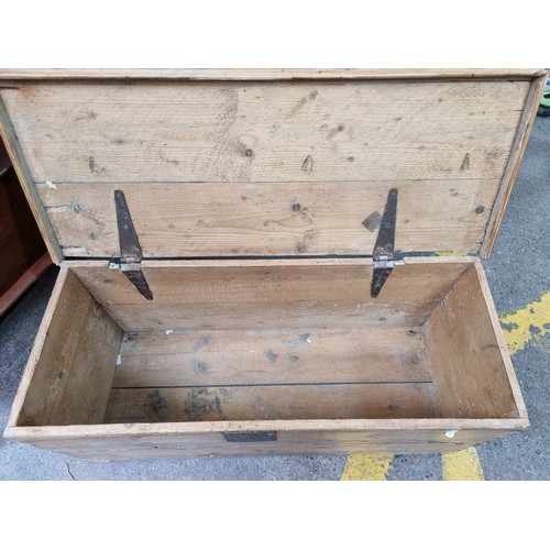 603 - An antique Pine storage chest with brass hinges.