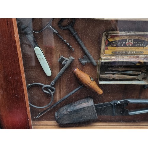 341 - Star Lot - A vintage shadow box containing a mix of antique tools, keys, and a loom. H50cm x W78cm