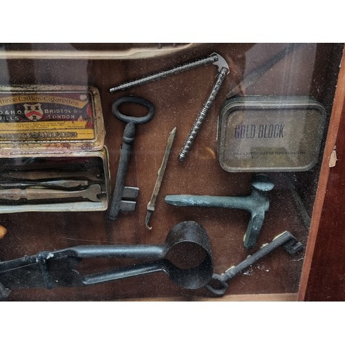 341 - Star Lot - A vintage shadow box containing a mix of antique tools, keys, and a loom. H50cm x W78cm