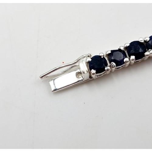 9 - Star lot : A stunning 17 gram natural Blue Sapphire sterling silver tennis bracelet. All stones beau... 