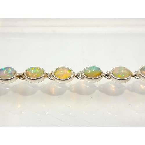 10 - Star lot : A truly beautiful Australian Fire Opal mounted  tennis bracelet, this fabulous example sh... 