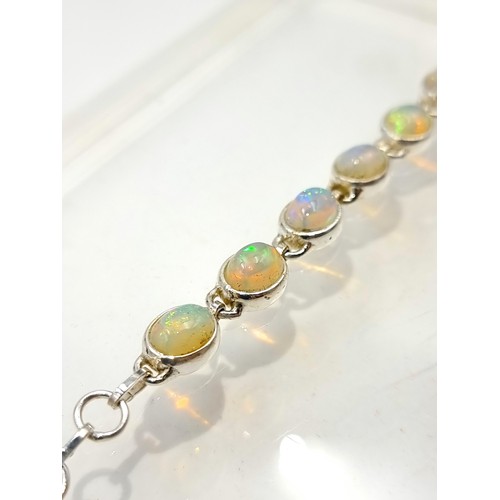 10 - Star lot : A truly beautiful Australian Fire Opal mounted  tennis bracelet, this fabulous example sh... 