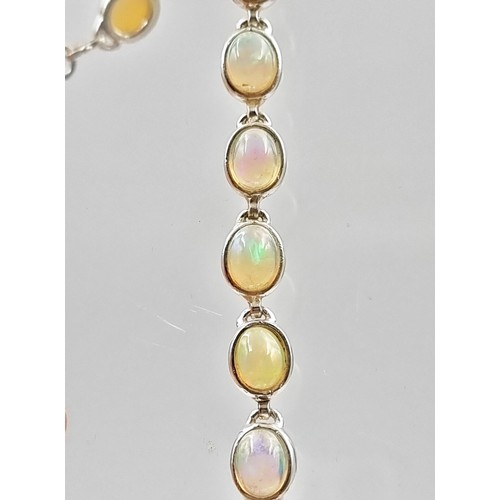 10 - Star lot : A truly beautiful Australian Fire Opal mounted  tennis bracelet, this fabulous example sh... 