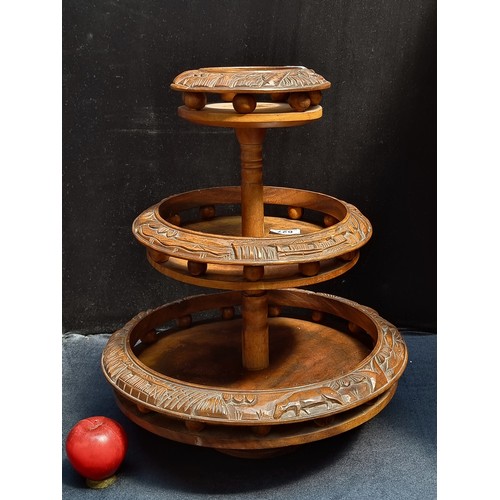 627 - A handsome hand-carved Indonesian cake stand. Crafted from walnut wood with buffalo and jungle motif... 