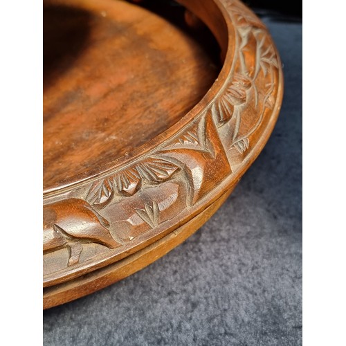 627 - A handsome hand-carved Indonesian cake stand. Crafted from walnut wood with buffalo and jungle motif... 