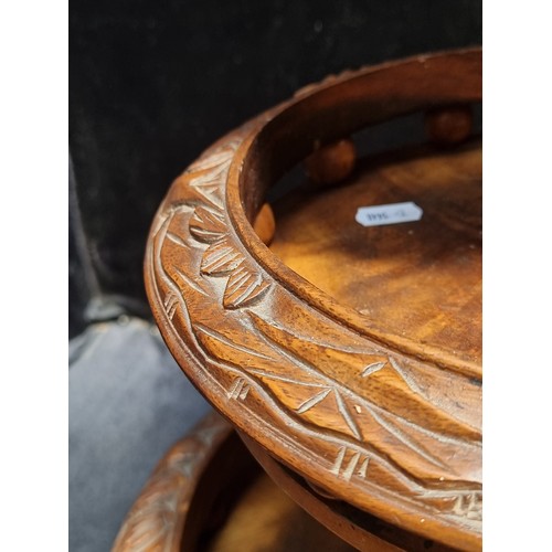 627 - A handsome hand-carved Indonesian cake stand. Crafted from walnut wood with buffalo and jungle motif... 