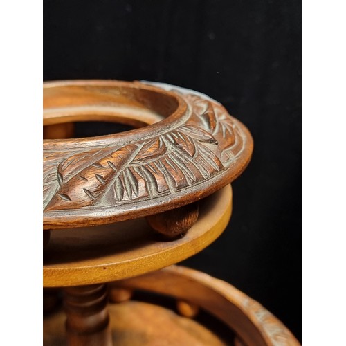 627 - A handsome hand-carved Indonesian cake stand. Crafted from walnut wood with buffalo and jungle motif... 