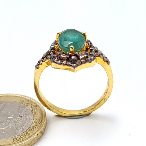 3 - Star lot : A striking Marquise Emerald and Diamond ring, set beautifully with an intricate mount and... 