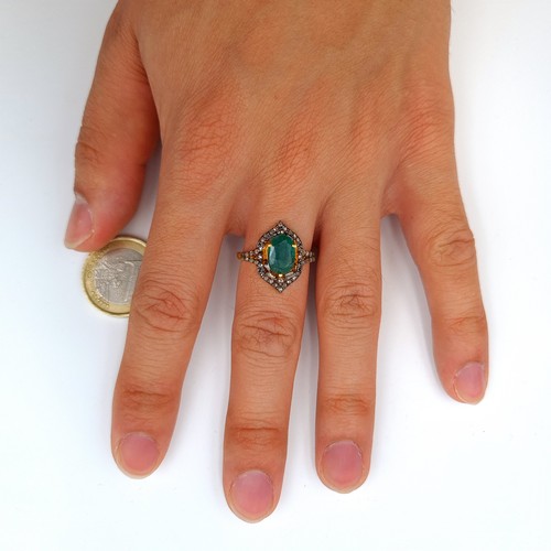 3 - Star lot : A striking Marquise Emerald and Diamond ring, set beautifully with an intricate mount and... 