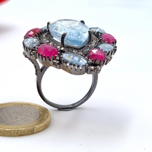 4 - Star Lot : An impressive Aquamarine, Ruby and Diamond floral ring, featuring a large tear drop cut c... 