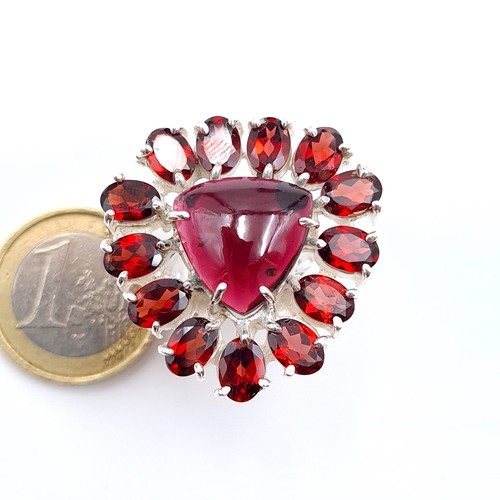 12 - Star Lot : A striking and unusual example of an Amethyst and  Garnet stone cocktail ring, featuring ... 