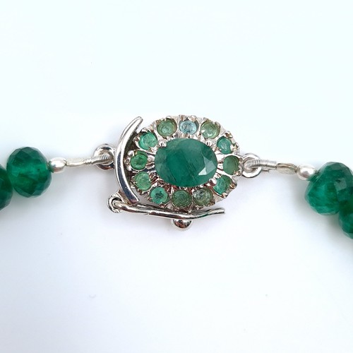 14 - Star Lot : An impressive example of a graduated natural Emerald stone necklace, set with a large 250... 