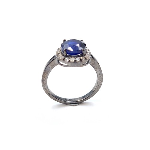 15 - Star Lot : A mesmerising natural Blue Sapphire and Diamond ring, featuring a cushion cut centre ston... 