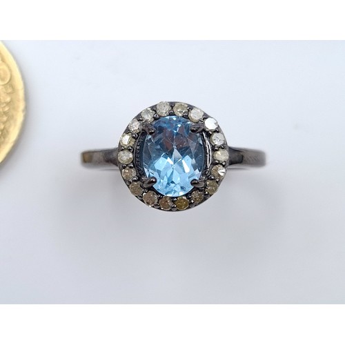 23 - A certified natural Blue Topaz and Diamond ring, with a central Topaz stone of 1.4 carats and a Diam... 