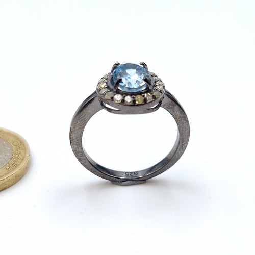 23 - A certified natural Blue Topaz and Diamond ring, with a central Topaz stone of 1.4 carats and a Diam... 