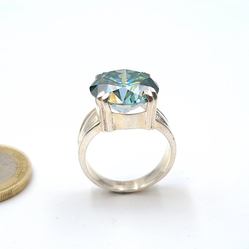 27 - Star Lot : A fully certified vivid Ocean Blue Moissanite stone ring, featuring a central stone of 8.... 