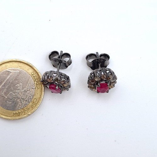 30 - An unusual pair of Ruby and Diamond floral earrings, featuring an intricate cluster setting and butt... 