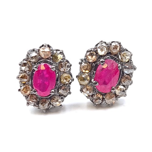 30 - An unusual pair of Ruby and Diamond floral earrings, featuring an intricate cluster setting and butt... 