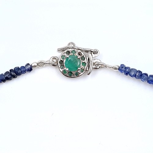 39 - A beautiful graduated 115 carat natural Blue Sapphire single strand necklace, set with an Emerald st... 