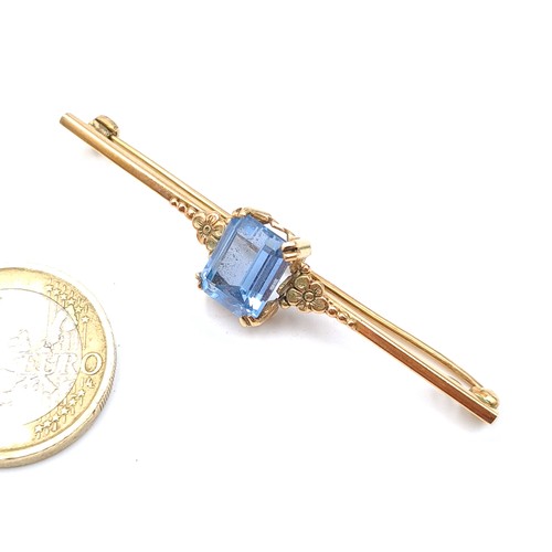 49 - Star Lot : A beautiful example of a vintage 9 carat gold brooch, featuring a fabulous facet cut Blue... 