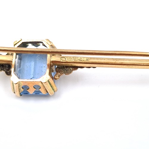 49 - Star Lot : A beautiful example of a vintage 9 carat gold brooch, featuring a fabulous facet cut Blue... 