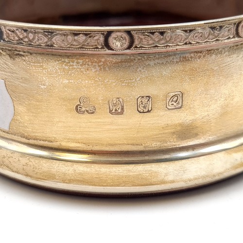 53 - An fine example on an Irish Silver wine coaster, featuring a central wood base and an intricate Dara... 