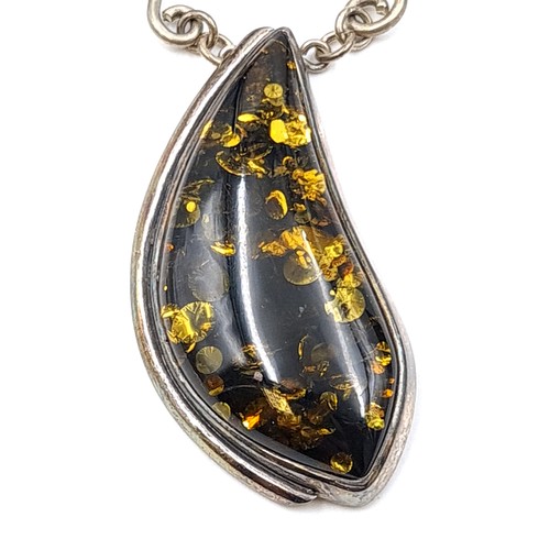 58 - A striking and vivid Baltic Amber sterling silver pendant necklace, featuring Celtic inspired accent... 