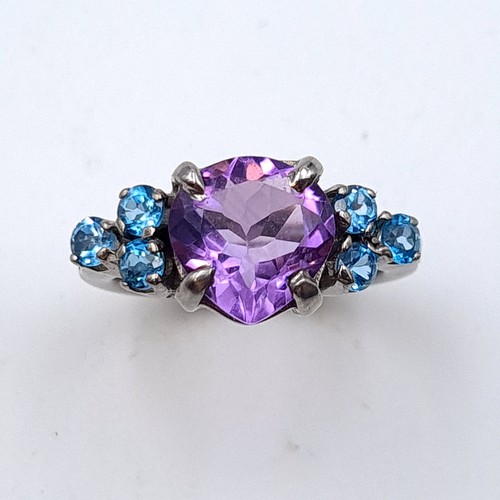 502 - An exquisite natural Amethyst and Blue Topaz ring, featuring a large fabulous central stone of 6.03 ... 