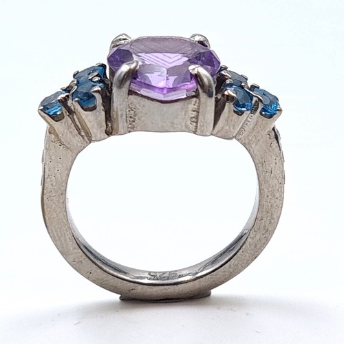 502 - An exquisite natural Amethyst and Blue Topaz ring, featuring a large fabulous central stone of 6.03 ... 