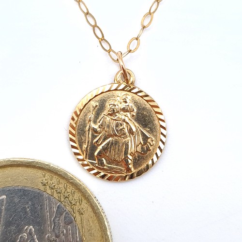 523 - A fine example of a 9 carat gold St Christopher necklace, featuring man and child in a medallion for... 