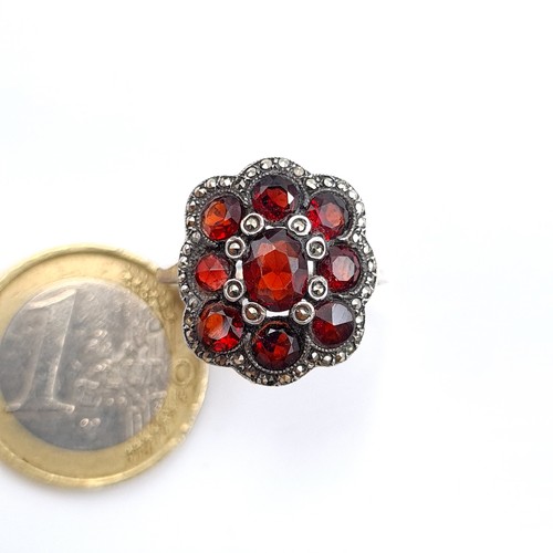 539 - A very attractive 9 stone Garnet floral ring, set with Marcasite setting and surround. Ring size: Q.... 