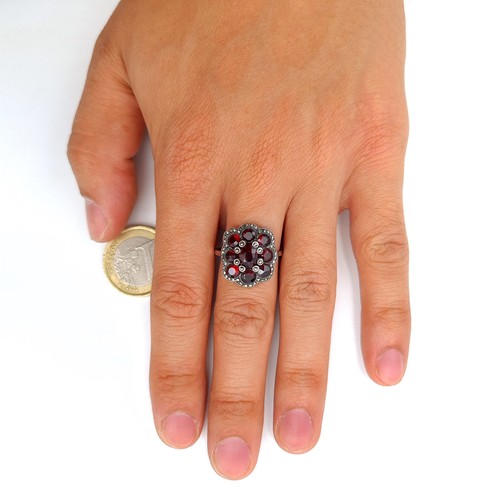 539 - A very attractive 9 stone Garnet floral ring, set with Marcasite setting and surround. Ring size: Q.... 