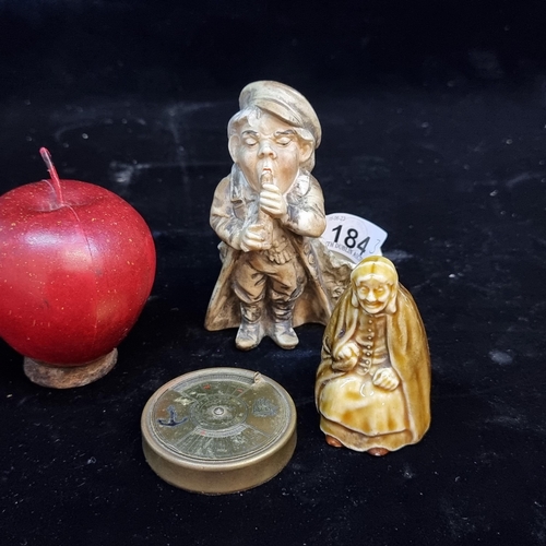 Three vintage collectables including a 50 year brass perpetual calender (works to 2038). With a Wade figure and a characterful Leprechaun figure.