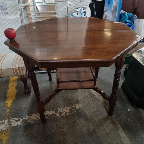 712 - An elegant vintage octagonal centre table of two tiers. Featuring turned legs and a neat sized raile... 