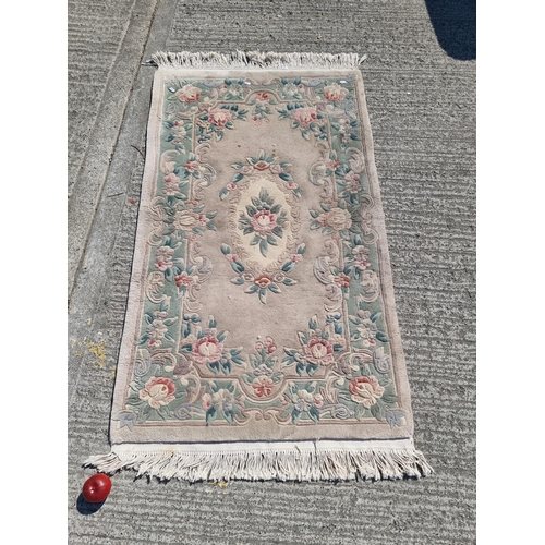 720 - A nicely proportioned Chinese wool floor rug. A well made example with a thick pile with a symmetric... 