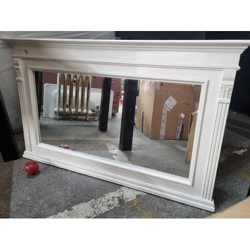 744 - A carved wood over mantle mirror. Flanked by reeded columns and finished in a cream gloss shade. W11... 