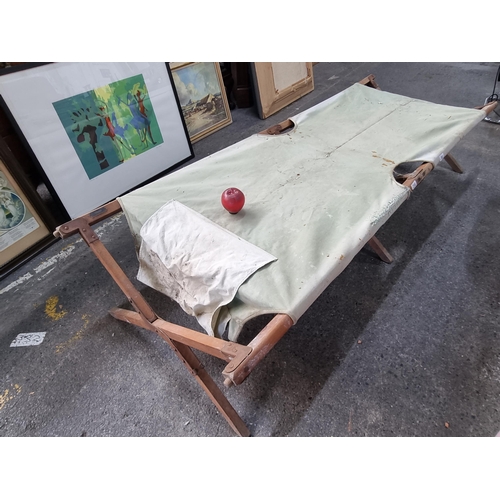 761 - A WWI military hospital stretcher. A fine example with wooden frame and heavy canvas stretcher fabri... 