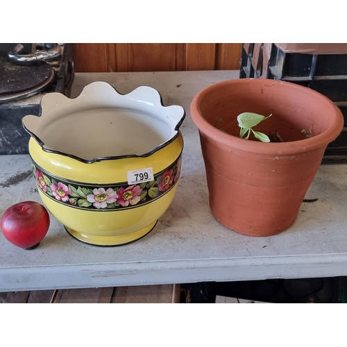 799 - Three charming terracotta planters including a bright yellow example with flower border, a small box... 