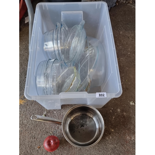 802 - A box filled with high quality glass cookware including pyrex casserole dishes and more.