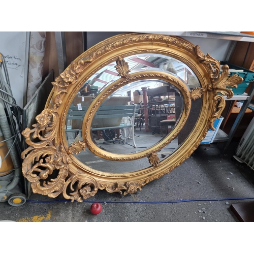 812 - Star Lot: an incredibly large oval Georgian style compartment wall mirror.  With a bevelled mirror i... 